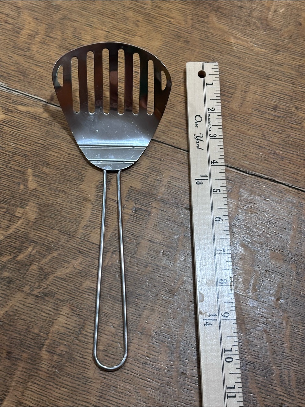 vintage metal slotted fryer scoop or spatula, commonly used with deep fryers